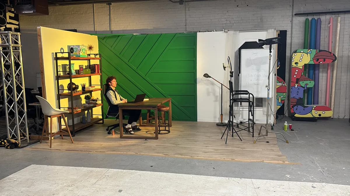 A film studio with a green wall set up for AI for Boomers promo videos