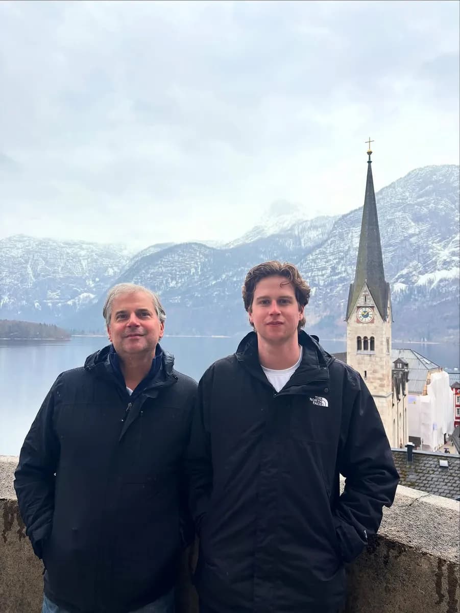 Andy with family by a lake and church in the Austrian Alps